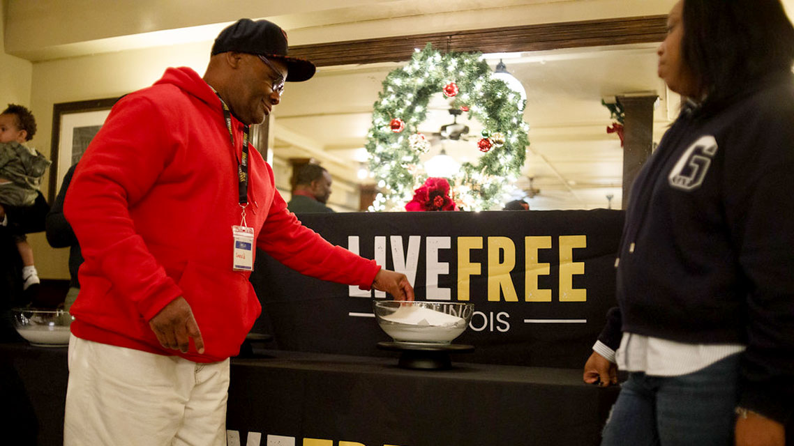 Two people stand by a festive table with a 